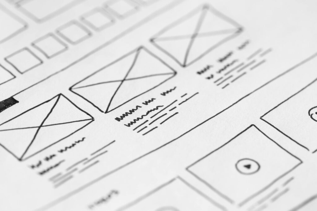 Website redesign wireframe sketches on paper showing the planning process for a small business website